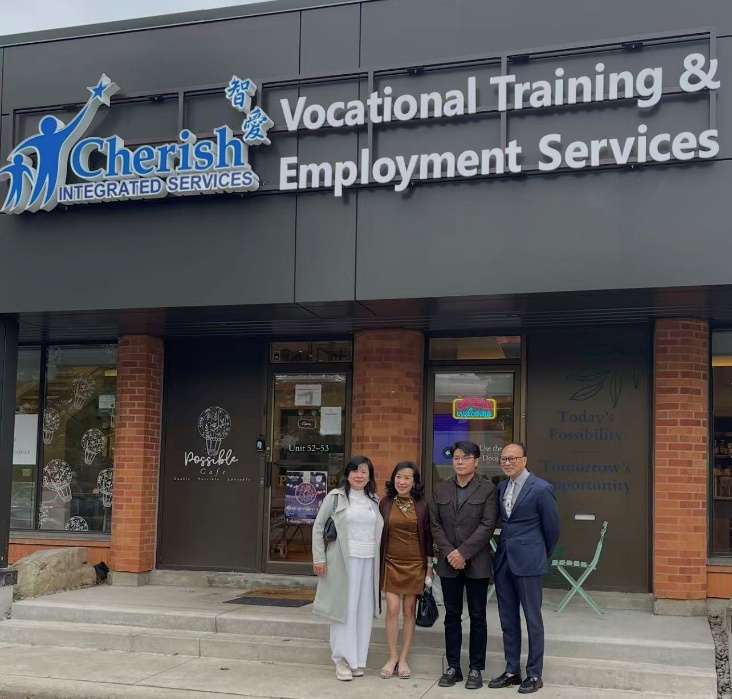 加中建筑协会代表与智爱中心创办人在中心门前合影